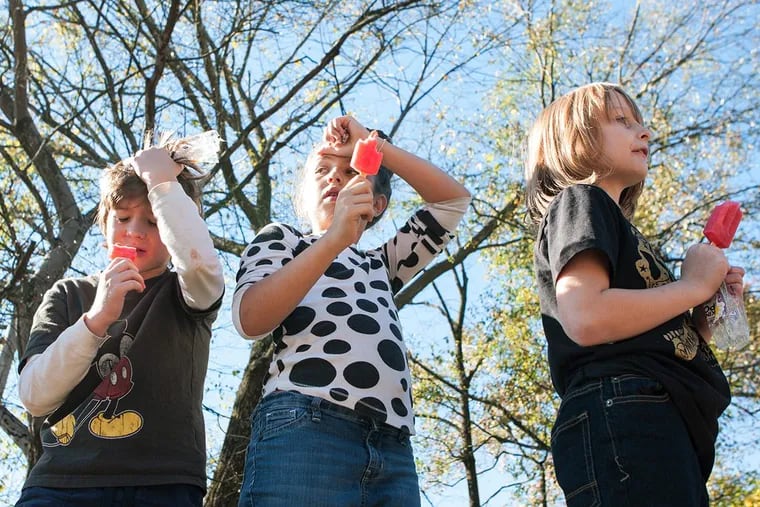 Kids hold their heads as they experience brain freeze while competing in a popsicle eating contest  in Atlanta.