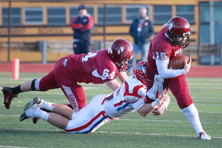 St. Joseph's Prep QB Chris Martin is tackled by Neshaminy's Denny Lord in the first quarter Saturday at Northeast.