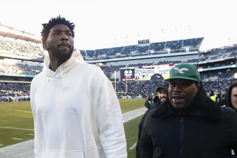 Joel Embiid looks on from the sidelines prior to the Eagles’ divisional playoff game against the Atlanta Falcons, Saturday, Jan. 13, 2018, at Lincoln Financial Field.