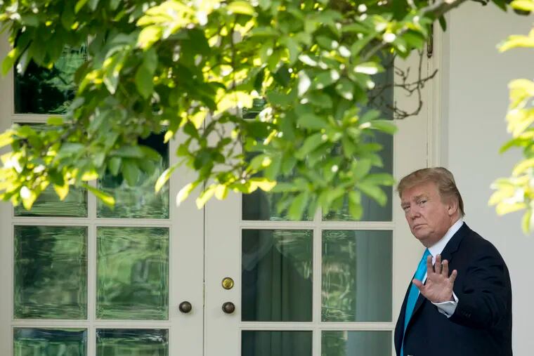 President Donald Trump waves as he walks towards the Oval Office in Washington, Thursday, May 23, 2019, after visiting the annual Flags In ceremony at Arlington National Cemetery.