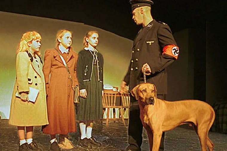 Robert Taffet holds Pluto, one of his other Rhodesian Ridgebacks, in a 2002 community play in Haddonfield about the Holocaust. (Elizabeth Robertson / Staff Photographer)