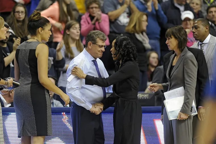 Connecticut head coach Geno Auriemma and South Carolina head coach Dawn Staley shaking hands after a February 2015 game in Storrs, Conn.