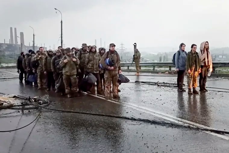 This photo taken from video released by the Russian Defense Ministry on Thursday shows Ukrainian servicemen who have left the besieged Azovstal steel plant in Mariupol.