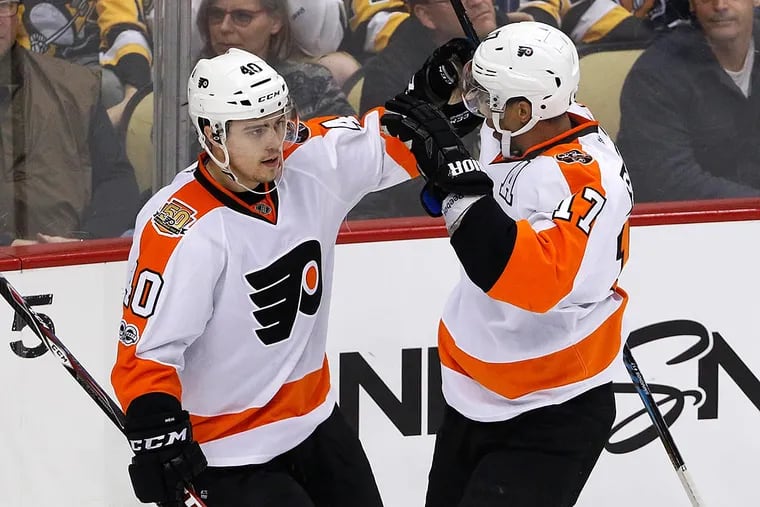 Philadelphia Flyers' Jordan Weal (40) celebrates his goal with Wayne Simmonds (17) in the first period of an NHL hockey game against the Pittsburgh Penguins in Pittsburgh, Sunday, March 26, 2017.