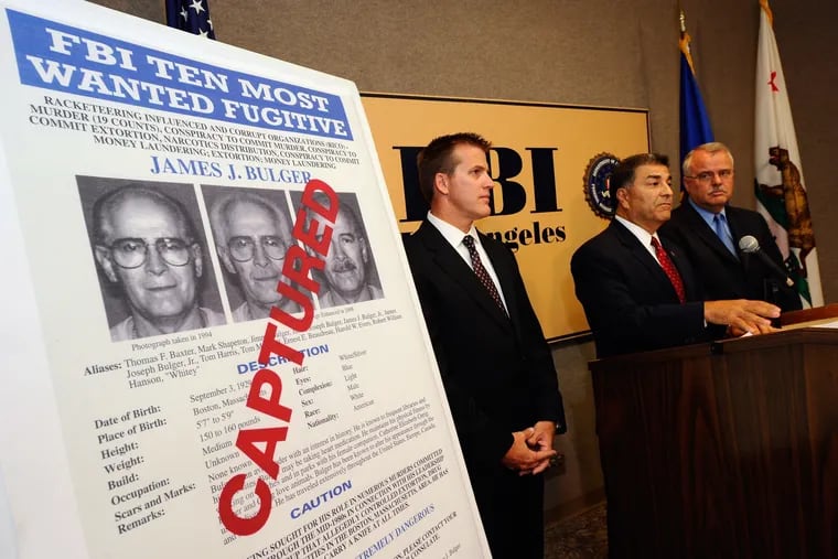 In this photo from June 23, 2011, Steven Martinez, center, FBI assistant director in charge in Los Angeles, Douglas Price, left, FBI Assistant Special Agent in Charge, and LAPD Deputy Chief, David Doan, Chief of Detectives, during a news conference to discuss the arrest of Boston crime boss James "Whitey'' Bulger and his companion, Catherine Greig, at the Los Angeles Federal Building.
