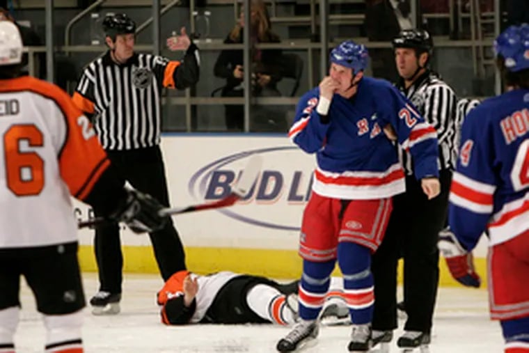 Rangers&#0039; Colton Orr (hand to mouth) skates away after leveling Todd Fedoruk in game&#0039;s opening seconds.