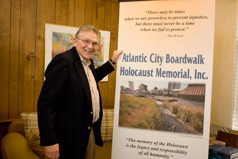 Rabbi Gordon Geller, president of the Atlantic City Boardwalk Holocaust Memorial, with a banner made by a member of his congregation at Temple Emeth Shalom in Margate. ( Ed Hille / Staff Photographer )