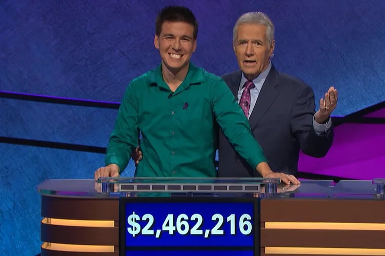 Jeopardy! star James Holzhauer, seen here with longtime host Alex Trebek, earned more than $2.4 million during his 32-game winning streak, the second most in the show's history.