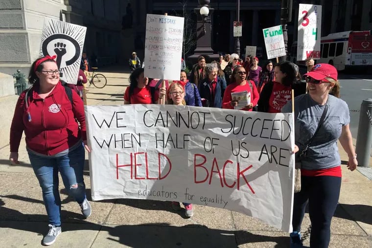 Philadelphia teachers from Bayard Taylor Elementary and Science Leadership Academy march around City Hall as part of Wednesday's  Day Without a Woman protest,
