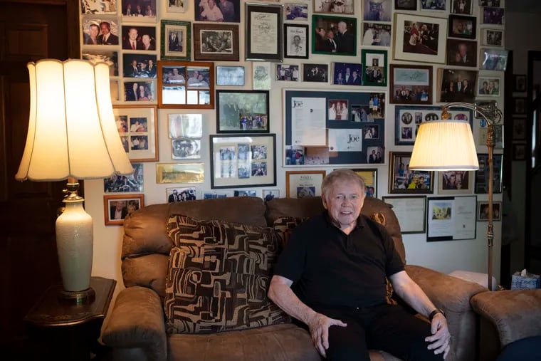 Former mayor Jimmy Connors in front of his wall of photographs of memorable meetings at his Scranton home.