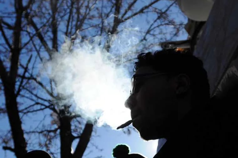 A man identifying himself as Wilfredo Gomez, 32, of north New Jersey, who claims he has a medical condition related to an accident, smokes marijuana in front of reporters in support of medical marijuana outside of the Greenleaf Compassion Center  in Montclair, N.J., following a news conference Thursday, Dec. 6, 2012.  Gomez is not a registered and approved patient and did not get his marijuana from the center. The establishment is New Jersey's first medical marijuana dispensary, and says it is serving only 20 clients per day at first, and only by appointment. (AP Photo/The Record of Bergen County, Mitsu Yasukawa) ONLINE OUT; MAGS OUT; TV OUT; INTERNET OUT;  NO ARCHIVING; MANDATORY CREDIT