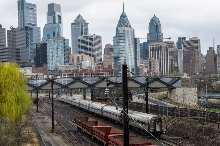 An Amtrak train travels near Interstate 76 in Philadelphia in 2021.