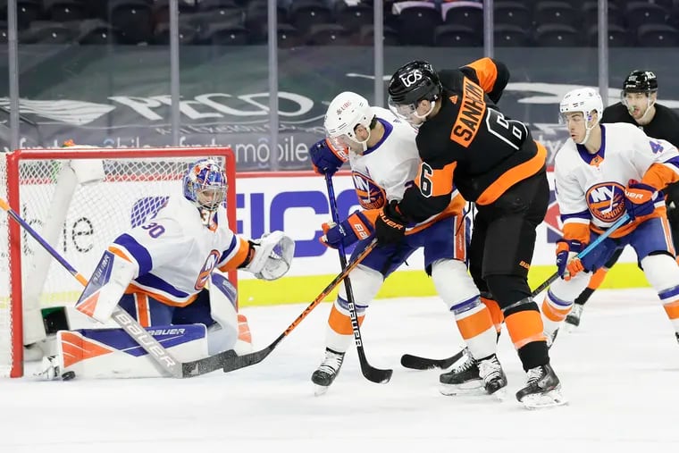 Flyers defenseman Travis Sanheim takes a shot, but goaltender Ilya Sorokin makes a first-period save on Sunday.
