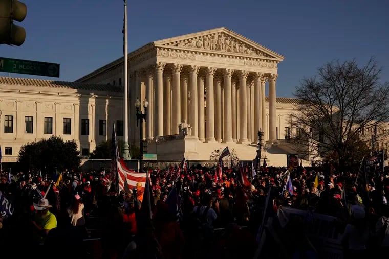 Supporters of President Donald Trump attend pro-Trump marches outside the Supreme Court Building in Washington. The Supreme Court is hearing arguments over whether the Trump administration can exclude people in the country illegally from the count used for divvying up congressional seats.