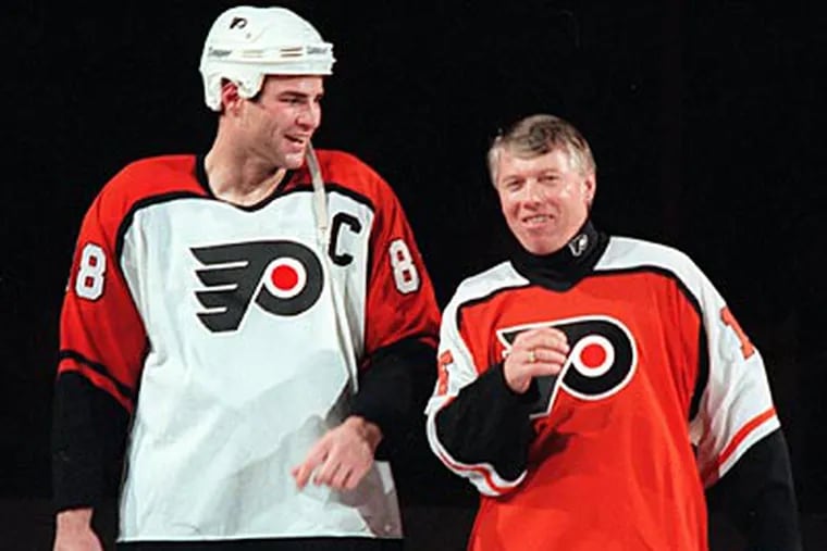 Eric Lindros skates with Bob Clarke during Old Timers Night in 1996. (Daily News File Photo)