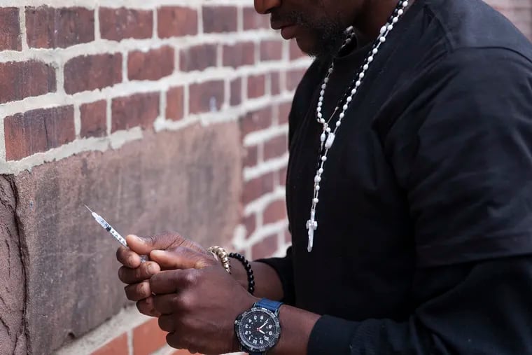 Andre Burton, 30, prepares to shoot heroin in Kensington on Tuesday afternoon, May 14, 2019. After overdose deaths dipped in 2018, they rose again in 2019, with Black and Latino communities particularly hard hit. Now, during the pandemic, overdose deaths among Black Philadelphians have surpassed those among white residents.