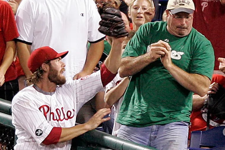Jayson Werth and a Phillies fan have trouble over a foul ball during Thursday night's game. (David Swanson / Staff Photographer)
