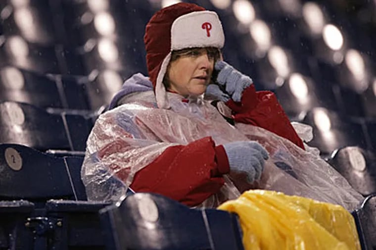 A fan as Game 5 of the World Series between the Philadelphia Phillies and the Tampa Bay Rays was suspended due to rain. (Yong Kim / Philadelphia Daily News)