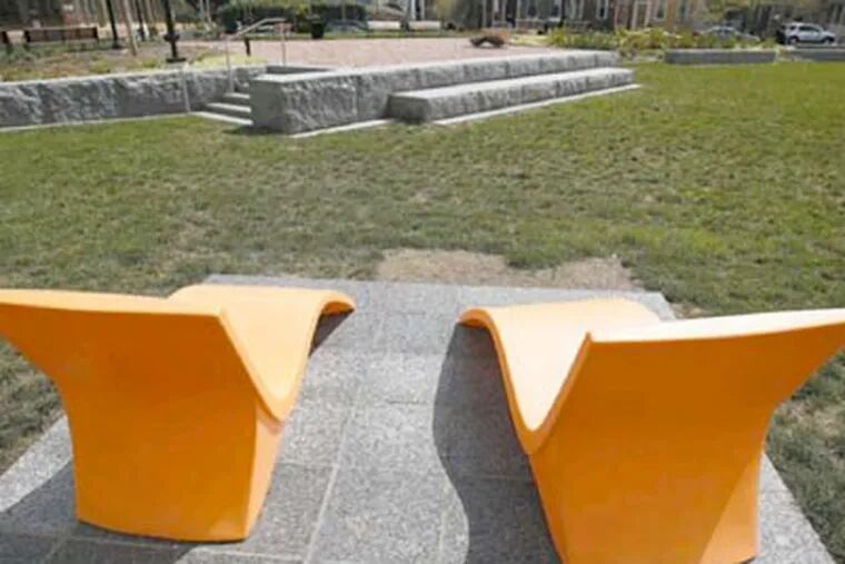 Orange chaise lounges offer an inviting place to sit in Hawthorne Park. The park is on part of the site of the demolished Martin Luther King Jr. plaza. (DAVID MAIALETTI / Staff Photographer)
