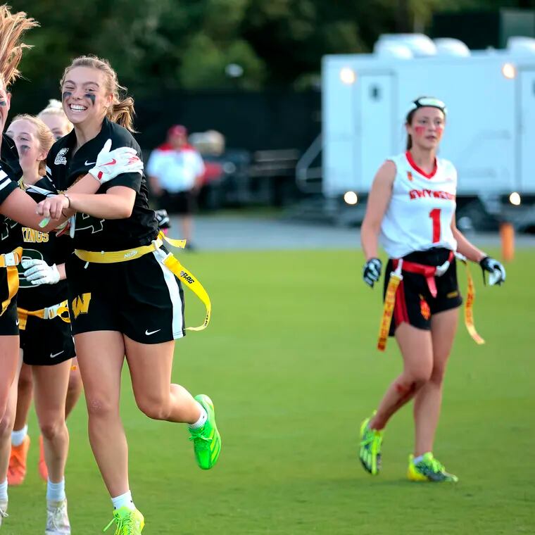 Lauren Greer, left, and Ava Renninger of Archbishop Wood celebrate after defeating Gwynedd Mercy in the Eagles’ Pennsylvania flag football championship at the Eagles Nova Care center on June 1, 2024.