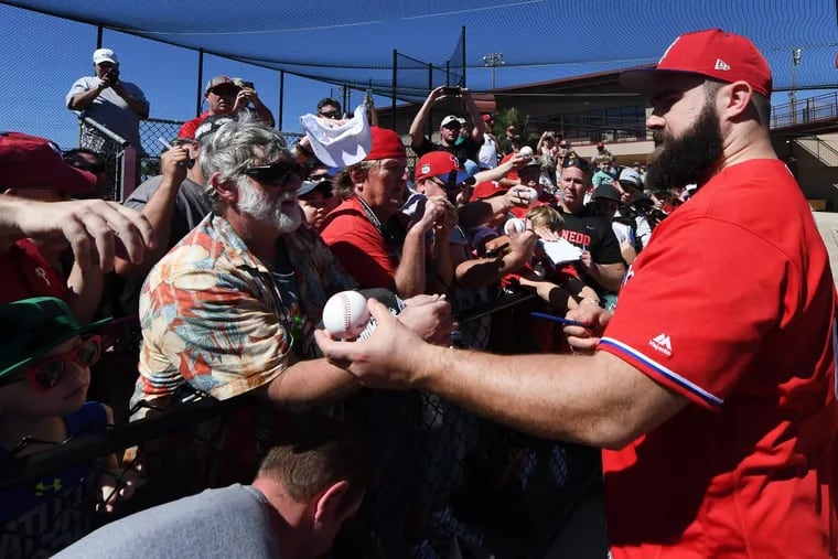 Jason Kelce autographs baseballs during his visit to Phillies spring training.