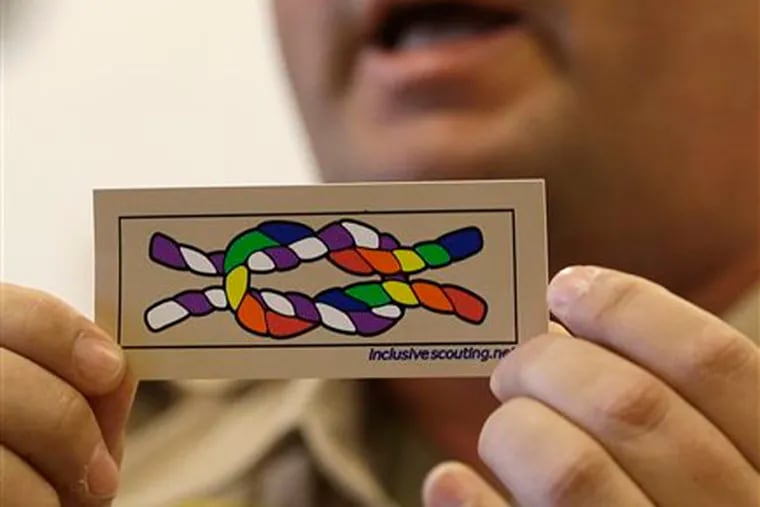 Former scout maser Mark Noel, of Hanover, NH, holds up a new merit badge of inclusion during a press conference at the Equal Scouting Summit being held near where the Boy Scouts of America are holding their annual meeting in Grapevine, Texas. (AP Photo/LM Otero)