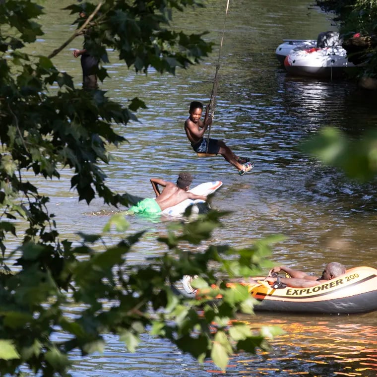 People cool off in the West Branch of the Brandywine River in at the ChesLen Preserve in Newlin Township, Chester County, on July 23, 2022.