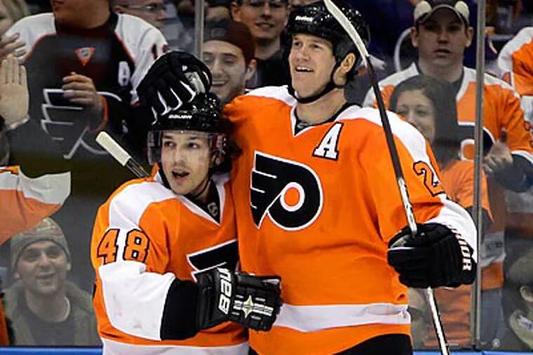Danny Briere (left) celebrates with Chris Pronger after scoring in the third period. (Seth Wenig/AP)
