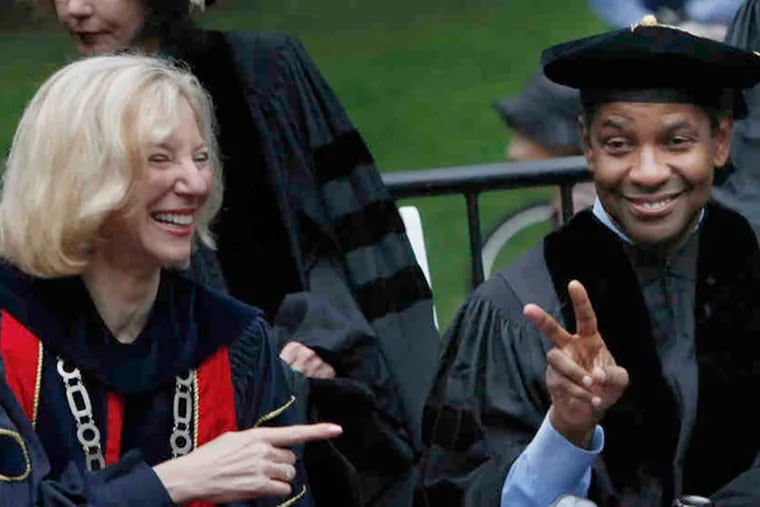 2011 file photo: Penn president Amy Gutmann and actor Denzel Washington wave to graduates in the procession at Franklin Field. Washington, whose son is a Penn sophomore, delivered the commencement address. (Michael S. Wirtz / Staff Photographer)