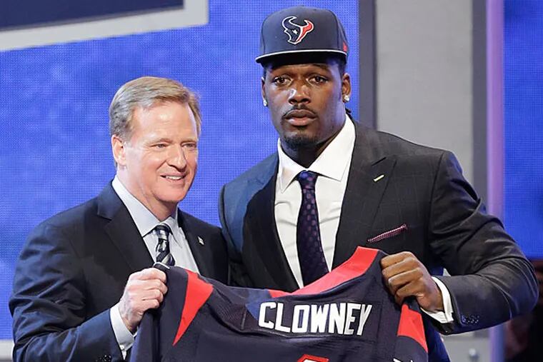South Carolina defensive end Jadeveon Clowney hold up the jersey for the Houston Texans first pick of the first round of the 2014 NFL Draft with NFL commissioner Roger Goddell, Thursday, May 8, 2014, in New York. (Frank Franklin II/AP)
