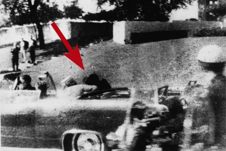 A Polaroid from Nov. 22, 1963 in Dallas, with arrow showing a theoretical bullet trajectory from the Grassy Knoll.
