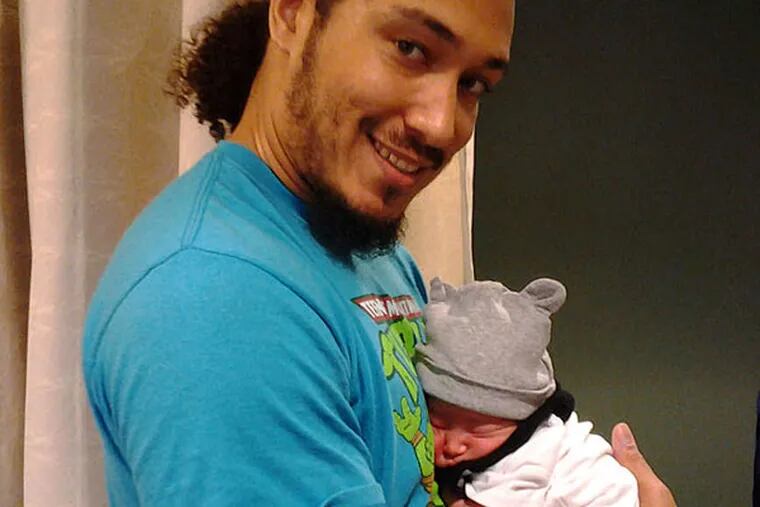Eric Jefferson holding newborn son Oliver Blaze Jefferson. (JULIEVETTE RIVERA)