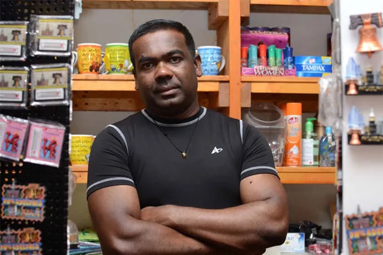 Selvadurai Pathmathasan, also known as Bob, got help keeping his store open and stocked thanks to a microloan program. (Andrew Thayer / Staff Photographer)