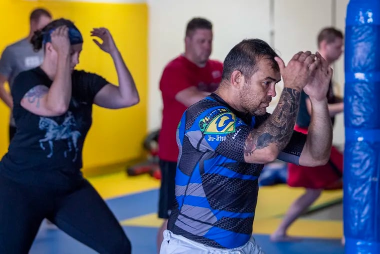 Alexandre Quintella teaches a free Brazilian Jiu-Jitsu class to area police officers last month at his Quintella MMA studio in Folsom, Pa.