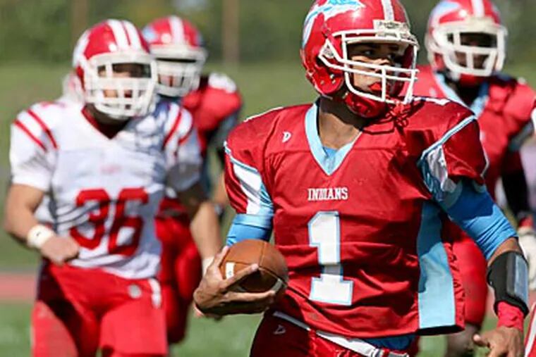 Pennsauken quarterback Manny Cortez, center, led his team to a victory against Cherry Hill East. (Charles Fox / Staff Photographer)
