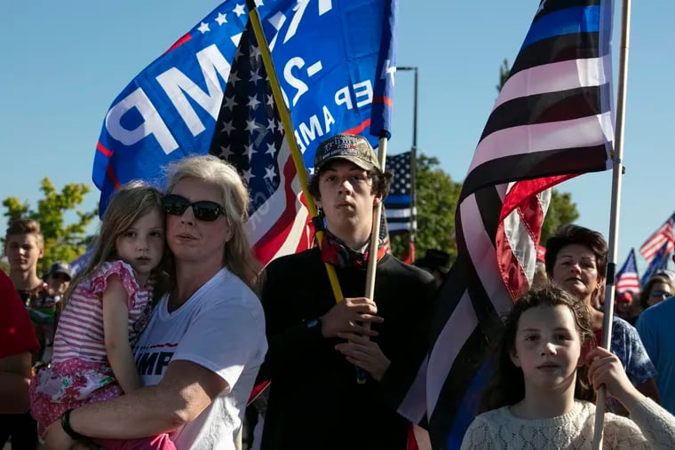 Supporters of President Donald Trump listen to speeches at a rally before a car parade, Saturday, Aug, 29, 2020, in Clackamas, Ore. (AP Photo/Paula Bronstein)