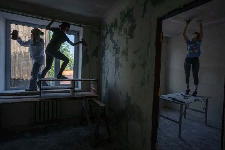 Women working to reconstruct a fire station damaged by Russian strikes in Makariv, a suburb of Kyiv, in June. Volunteers have worked since the start of the war to rebuild the battered nation.