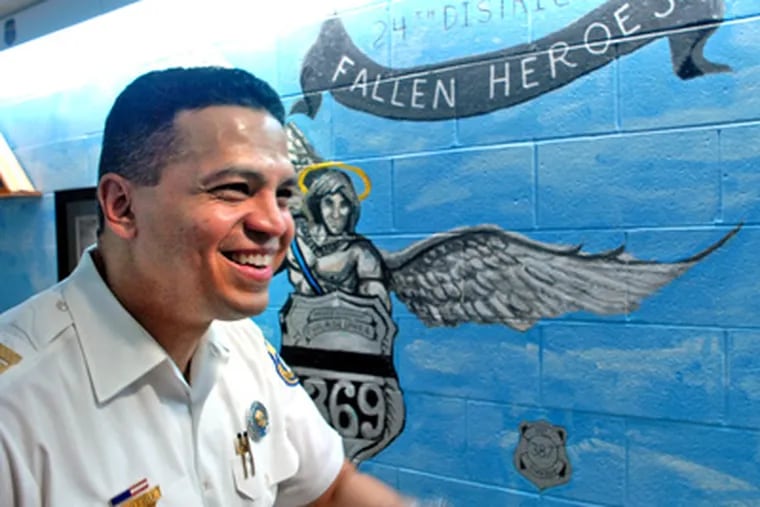 Indicted Inspector Daniel Castro was captain of the 24th District in June 2009 as he paused near a mural there honoring officers killed in the line of duty.