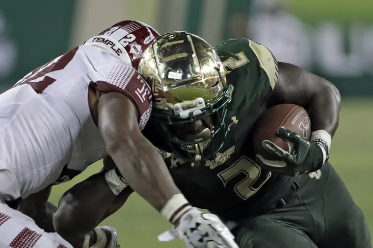 South Florida running back D'Ernest Johnson (2) hits Temple linebacker Chapelle Russell (22) on a run during the second half of an NCAA college football game Thursday, Sept. 21, 2017, in Tampa, Fla. (AP Photo/Chris O'Meara)