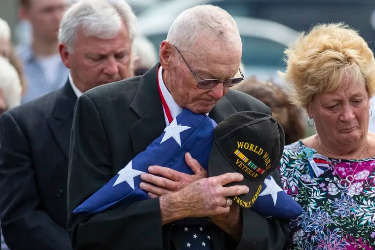 Gene D. Costill, brother to U.S. Fireman 3rd Class Harold K. "Brud" Costill, embraces the flag presented to him during the interment of his brother's remains at the Cedar Green Cemetery in Clayton, N.J., on Saturday, Sept. 14, 2019.