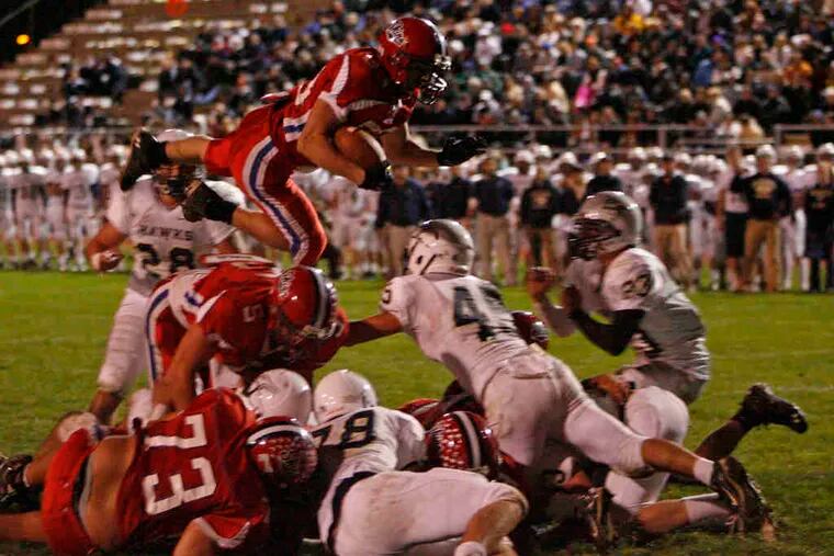 Neshaminy's Anthony Woodroffe takes the high road, vaulting over the pile for a touchdown in a 28-21 win over Council Rock South on Oct. 15. Neshaminy takes on visiting Upper Dublin, while Council Rock South hosts Souderton in Friday's District 1 Class AAAA playoff openers.