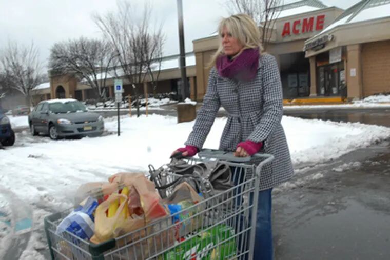 Karen Noworyta of Hainesport walks with a cart full of groceries outside of the Cinnaminson Acme in New Jersey. (April Saul / Staff Photographer)
