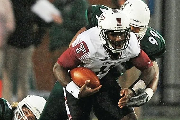 Charlotte 49ers linebacker Nick Cook, left, and defensive lineman Brandon Bankes, right, look to make the tackle on Temple Owls quarterback P.J. Walker during first quarter action at Jerry Richardson Stadium on Friday, October 2, 2015.