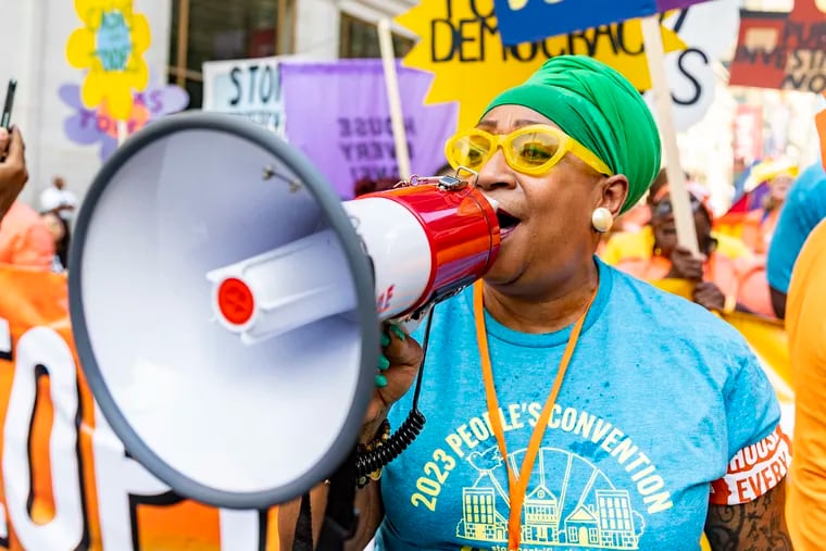 Fari Ghamina Tumpe, of Washington, with Spaces in Action D.C., leads chants with fellow protesters during the 2023 People’s Convention Rally in Philadelphia on Saturday.