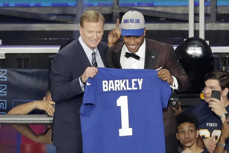 Penn State's Saquon Barkley, right, poses with commissioner Roger Goodell after being selected by the New York Giants during the first round.