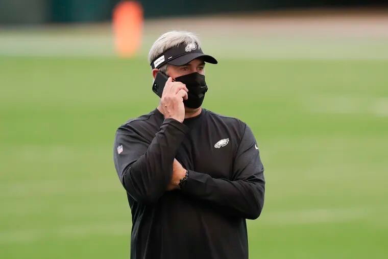 Eagles Head Coach Doug Pederson on his phone before the Eagles played the Giants on Thursday.