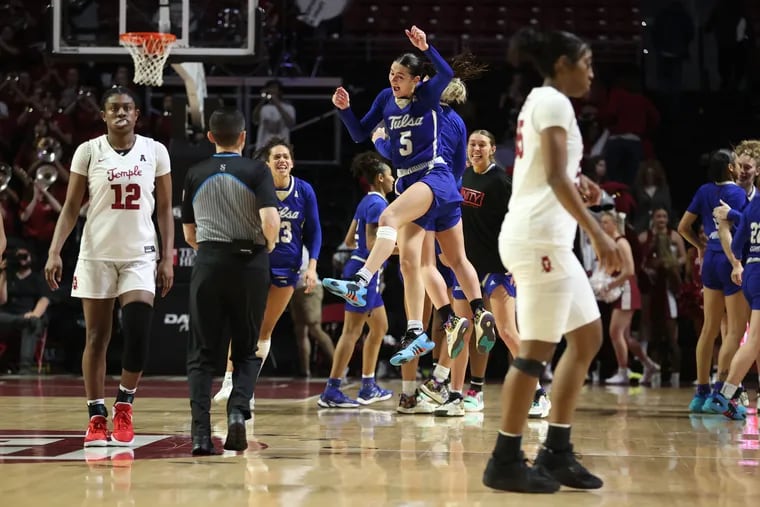 Delanie Crawford, center, and Tulsa teammates celebrate as Temple players walk off the court after its loss to Tulsa at the Liacouras Center on Feb. 28.