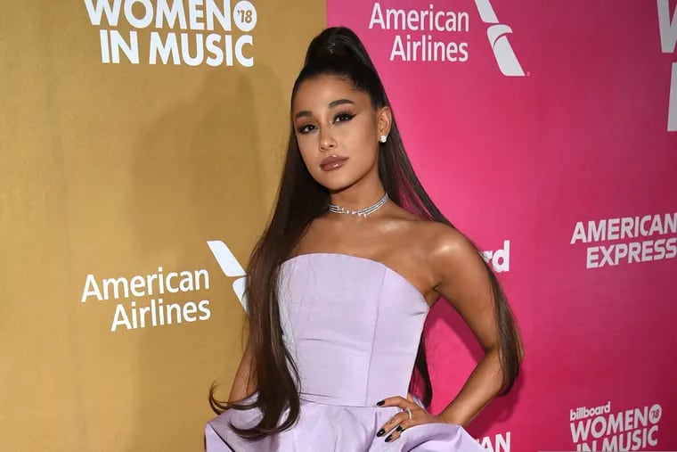 FILE - In this Dec. 6, 2018, file photo, Ariana Grande attends the 13th annual Billboard Women in Music event at Pier 36 in New York. Grande is telling her fans that she has a bad sinus condition that has made her “very sick” and might force her to cancel upcoming shows on her world tour. Grande, 26, says in videos posted on Instagram Saturday, Nov. 16, 2019, that “my throat and head are still in so much pain.”
