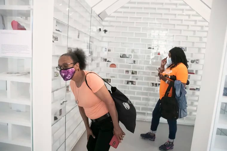 Cheryl Pedro (left) and Yullio Robbins tour the Gun Violence Memorial Project exhibit in Washington, D.C. on Friday, June 4, 2021. Pedro and Robbins are two Philly moms who lost sons to gun violence and donated to the exhibit. They visited for the first time on Friday.