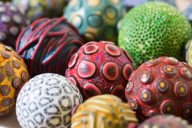 Some clay beads. The artists' techniques have evolved and expanded to include such things as a pasta maker and dental tools.